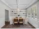 Elegant dining room with a decorative chandelier, stylish shelving, and a view to the window at 10906 Charmont Pl, Huntersville, NC 28078