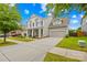 Attractive two-story house featuring a spacious driveway, two-car garage, and neatly landscaped yard at 10906 Charmont Pl, Huntersville, NC 28078