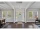 Bright and airy foyer featuring a chandelier, hardwood floors, and a view of the front entrance at 10906 Charmont Pl, Huntersville, NC 28078