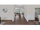 Open hallway featuring beautiful hardwood floors, elegant moldings, and views into the living spaces at 10906 Charmont Pl, Huntersville, NC 28078