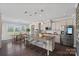 Open kitchen featuring stainless appliances, granite counters, an island with seating, and a view to the yard at 10906 Charmont Pl, Huntersville, NC 28078