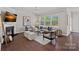 Inviting living room with a fireplace, large windows, stylish decor, and plenty of seating at 10906 Charmont Pl, Huntersville, NC 28078