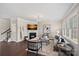 Cozy living room features a fireplace, large windows, comfortable seating, and elegant decor at 10906 Charmont Pl, Huntersville, NC 28078
