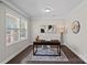 Well-lit office space with a modern desk, stylish decor, and large windows offering ample natural light at 10906 Charmont Pl, Huntersville, NC 28078