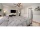Cozy bedroom featuring a comfortable bed, ceiling fan, dresser, and easy access to an en-suite bathroom at 11102 Sundown Ln, Charlotte, NC 28226