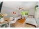 Bright bedroom featuring two twin beds, a ceiling fan, and desk at 11102 Sundown Ln, Charlotte, NC 28226