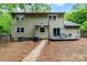 Back of house with a deck, sliding glass door, and a gravel walkway at 11102 Sundown Ln, Charlotte, NC 28226