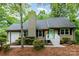 Charming single-story home featuring manicured landscaping, a quaint entrance, and a light-colored exterior at 11102 Sundown Ln, Charlotte, NC 28226