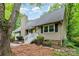 Home exterior featuring a chimney, a white wooden porch and stairs, and neutral colored siding at 11102 Sundown Ln, Charlotte, NC 28226