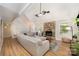 Spacious living room showcasing a stone fireplace, light wood floors, and a comfortable sofa at 11102 Sundown Ln, Charlotte, NC 28226