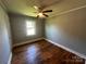 Cozy bedroom with hardwood floors, neutral walls, and a ceiling fan at 1119 Sanders St, Rock Hill, SC 29732