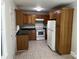 Cozy kitchen featuring white appliances, wood cabinets, and tile flooring at 1119 Sanders St, Rock Hill, SC 29732