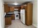 Traditional kitchen with white appliances, tile floors, and wooden cabinets at 1119 Sanders St, Rock Hill, SC 29732