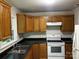 Functional kitchen with white appliances, wood cabinets and dark countertops at 1119 Sanders St, Rock Hill, SC 29732