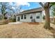 Back exterior of a home with light green siding, windows, and a concrete patio at 112 Bickett Ave, Gastonia, NC 28052