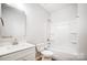 This bathroom offers a shower-tub combo, modern vanity with sink, and tile floors at 112 Bickett Ave, Gastonia, NC 28052
