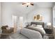 This bedroom features a neutral color palette, a ceiling fan, and access to the bathroom and closet at 112 Bickett Ave, Gastonia, NC 28052