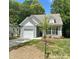 Charming home features a manicured lawn, attached garage, and a classic craftsman-style facade at 112 Bickett Ave, Gastonia, NC 28052