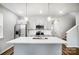 Kitchen features stainless steel appliances, white cabinets, subway tile backsplash, and an island with pendant lights at 112 Bickett Ave, Gastonia, NC 28052