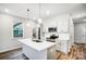 Kitchen features stainless steel appliances, white cabinets, subway tile backsplash, and an island with pendant lights at 112 Bickett Ave, Gastonia, NC 28052