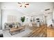 Bright open living room with modern furniture, dining area, and an open kitchen with stainless appliances at 112 Bickett Ave, Gastonia, NC 28052