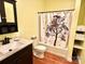 Bright bathroom with a black vanity, and a shower/tub with a tree-themed curtain at 1140 Fern Hill Rd, Mooresville, NC 28117