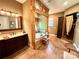 Elegant bathroom featuring tile floors, jacuzzi tub with wood accents, and vanity with solid surface countertops at 1140 Fern Hill Rd, Mooresville, NC 28117