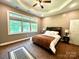 Cozy bedroom with a tray ceiling, large windows, plush carpeting, and a comfortable bed at 1140 Fern Hill Rd, Mooresville, NC 28117
