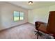Neutral bedroom with natural light showcases a window, carpeted floors and desk at 1140 Fern Hill Rd, Mooresville, NC 28117