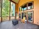 Relaxing screened deck area with rocking chairs, views of wooded back yard at 1140 Fern Hill Rd, Mooresville, NC 28117