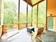 Relaxing screened deck area with rocking chairs, views of wooded back yard at 1140 Fern Hill Rd, Mooresville, NC 28117