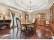 Elegant dining room featuring hardwood floors, a large table, and traditional furnishings at 1140 Fern Hill Rd, Mooresville, NC 28117
