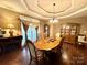 Elegant dining room featuring a tray ceiling, hardwood floors, fireplace, and classic furnishings at 1140 Fern Hill Rd, Mooresville, NC 28117