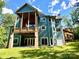A spacious home with a large deck, a well-maintained lawn, and picturesque views, ideal for outdoor living and entertainment at 1140 Fern Hill Rd, Mooresville, NC 28117