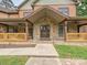 Charming stone and siding home featuring a covered porch with decorative railing and inviting front door at 1140 Fern Hill Rd, Mooresville, NC 28117