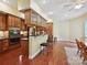 Well-equipped kitchen with wood cabinets, stainless steel appliances, and island with seating at 1140 Fern Hill Rd, Mooresville, NC 28117