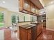 Kitchen featuring wood cabinets, granite counters, and open layout to the living room at 1140 Fern Hill Rd, Mooresville, NC 28117