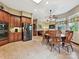 Open kitchen and dining area with stainless steel appliances and ample cabinet space at 1140 Fern Hill Rd, Mooresville, NC 28117