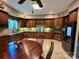 This updated kitchen features custom wood cabinets, granite countertops, tile floors, and modern appliances at 1140 Fern Hill Rd, Mooresville, NC 28117