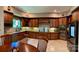 This updated kitchen features custom wood cabinets, granite countertops, tile floors, and modern appliances at 1140 Fern Hill Rd, Mooresville, NC 28117