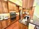 Well-lit kitchen with stainless steel appliances, granite countertops, and custom wood cabinets at 1140 Fern Hill Rd, Mooresville, NC 28117