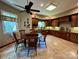 Spacious kitchen with custom wood cabinets, tile floors, a central table, and modern appliances at 1140 Fern Hill Rd, Mooresville, NC 28117