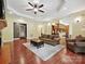 Spacious living room with hardwood floors, fireplace, and open layout to the kitchen at 1140 Fern Hill Rd, Mooresville, NC 28117