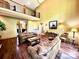 Spacious living room with high ceilings, balcony, hardwood floors, and views of the back yard at 1140 Fern Hill Rd, Mooresville, NC 28117