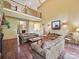 Open living room with hardwood floors, high ceilings, and a view of the second-story balcony at 1140 Fern Hill Rd, Mooresville, NC 28117
