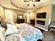 Comfortable main bedroom with carpet, a cozy bed, dresser, fireplace, and soothing neutral decor at 1140 Fern Hill Rd, Mooresville, NC 28117