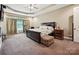 Spacious main bedroom with neutral carpeting, tray ceilings and abundant natural light at 1140 Fern Hill Rd, Mooresville, NC 28117