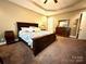 Relaxing main bedroom with carpet, a comfortable bed, dresser, and neutral decor for a peaceful retreat at 1140 Fern Hill Rd, Mooresville, NC 28117