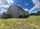View of the back of the house showing green siding, windows, and the yard at 11505 Sweetbriar Ridge Dr, Charlotte, NC 28269