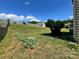 Sloping backyard with a partial view of the back of the house and a wooden privacy fence at 11505 Sweetbriar Ridge Dr, Charlotte, NC 28269